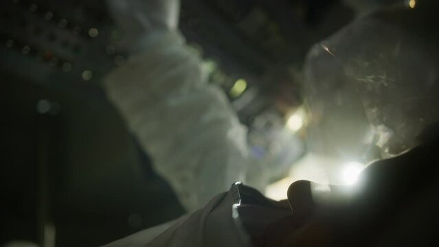 Silhouette of astronaut in shuttle - side, medium shot