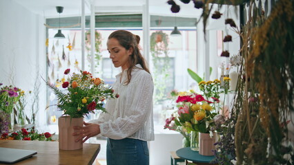 Flower store retailer work make bouquet in beautiful spring plant shop business.