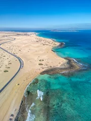 Tuinposter The drone aerial view of Corralejo Natural Park and grand Corralejo beach. Corralejo Natural Park is the best place to go to enjoy the desert beauty of Fuerteventura. © yujie