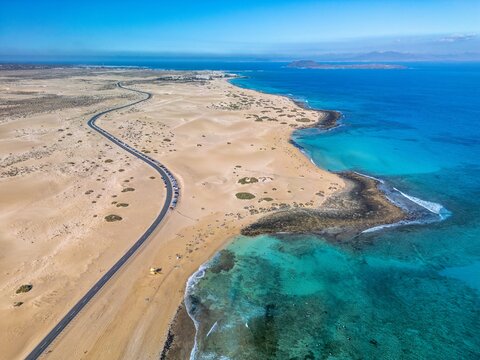 The drone aerial view of Corralejo Natural Park and grand Corralejo beach. Corralejo Natural Park is the best place to go to enjoy the desert beauty of Fuerteventura.