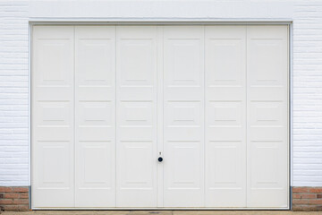 Modern classic garage or storage room door, White painted hinged wooden door with brick wall on the side, Home parking front gate.