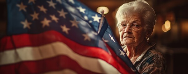 Elderly female veteran holds up an American flag for the memorial day,