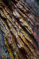 closeup of water flowing through layered eroded rock slabs