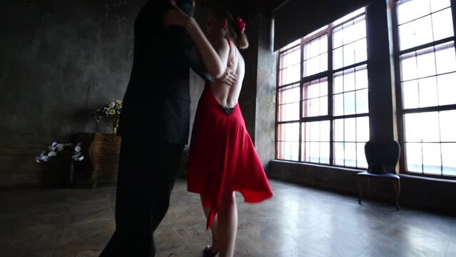Close up of young pair dancing tango in retro room