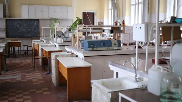 Light switch in empty chemical laboratory with many tables