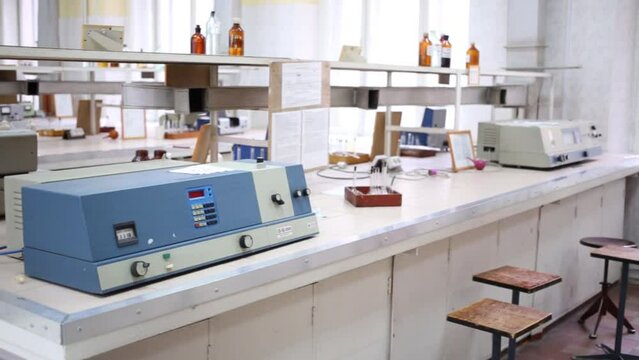 Different devices on tables in empty chemical laboratory