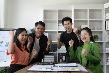 Happy diverse business team celebrating success and having fun all together, Celebration in the office, celebrating a success with raised arms and joyful expressions,