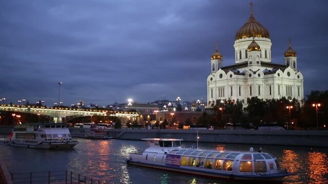 Modern ships sail on river near Christ Saviour Cathedral in Moscow