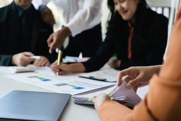 Fototapeta premium Two women and two men in a business meeting, Diverse business people laughing during a meeting, Business colleagues discussing strategy in the office, Business people negotiating at boardroom.