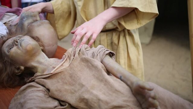 Assistant wiping cloth rubber doll of ancient people at festival