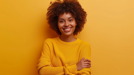 Black woman smiling in a yellow sweater