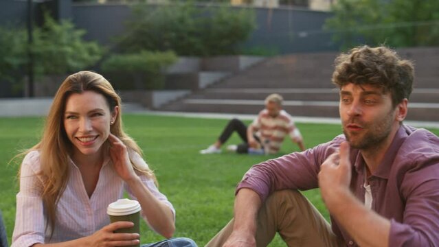 Smiling friends sitting park loan closeup. Happy students holding coffee cup