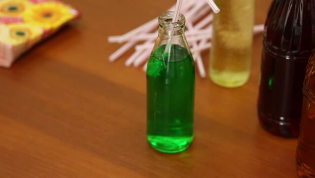 M & Ms sweets and bottles of drinks on table. 