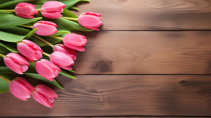 Pink tulips on wooden background with copy space.