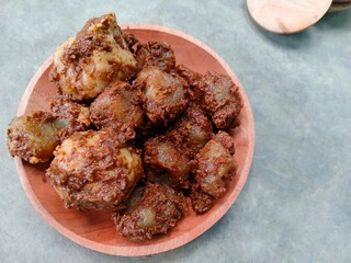 Siomay, traditional Indonesian snack on wooden plate. The snack is made from wheat flour dough containing meat and starch dough without filling, steamed and then mixed with peanut sauce. chewy