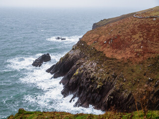 Stunning nature scene view on cliffs and ocean and cloudy sky. Slea head drive, county Kerry,...