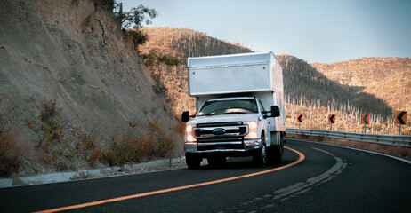 Large white road semi truck industrial semi-truck transporting cargo on dry van semi-trailer