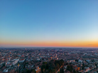 Fototapeta na wymiar Aerial view Citta Alta Bergamo, Italy. Drone aerial view of the old town during sunrise. Landscape at the city center, its historical buildings. 