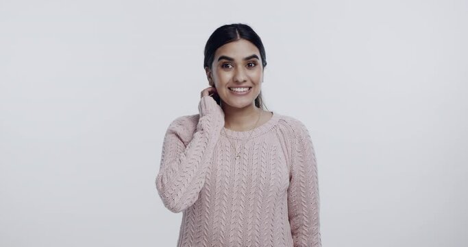 Woman, surprise or awkward face, shy about announcement or news with expression on white background. Oops, reaction and cringe in studio, embarrassed or wow with mistake or fail, nervous for problem