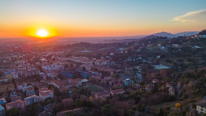 Citta Alta - Bergamo, Italy. Drone aerial view of the old town during sunrise. Landscape at the city center, its historical buildings. 