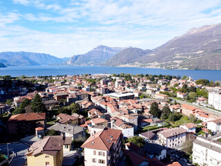 Fototapeta na wymiar The Italian valley of Lake Como among the picturesque foggy peaks of the Alps. 