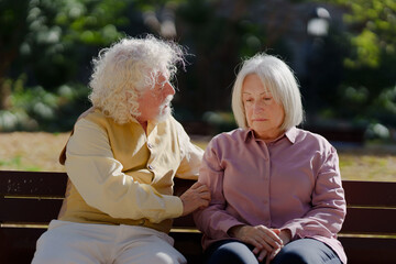 Senior man trying to comfort sad woman with depression. Alzheimer and dementia concept.