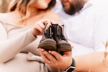 Couple is holding little baby boots