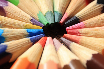 Macro photo of colored pencils together in a circle. Concept of desk tools.