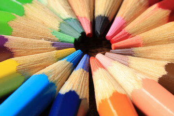 Macro photo of colored pencils together in a circle. Concept of desk tools.