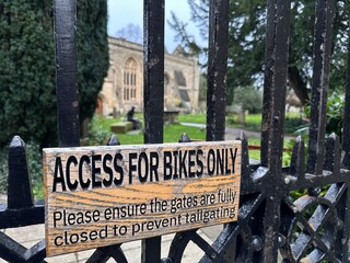 Wooden sign plaque access for bikes only on parkland gate