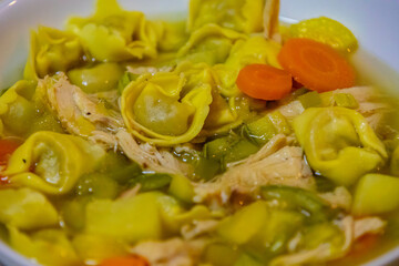 Traditional capeletti soup with chicken and vegetables. Typical winter dinner soup