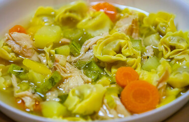 Traditional capeletti soup with chicken and vegetables. Typical winter dinner soup