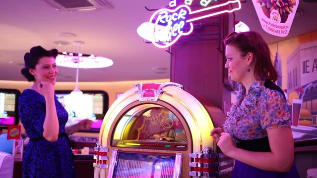 Two women with jukebox in Beverly Hills Diner 