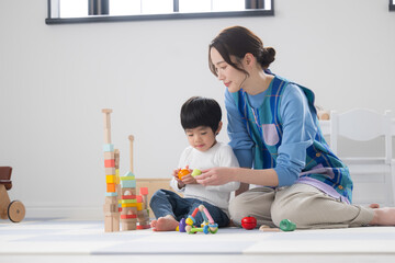 Preschool teacher with toddlers playing with building blocks - Nicely done! Image of new employment