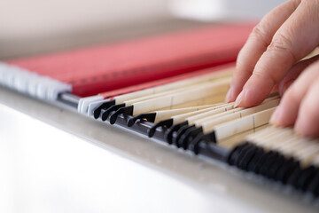 female hands through folders In Document Storage close-up, Home Archive, Record Keeping,...