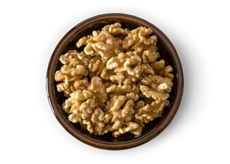 Walnuts in a baked clay dish seen from above isolated on empty background