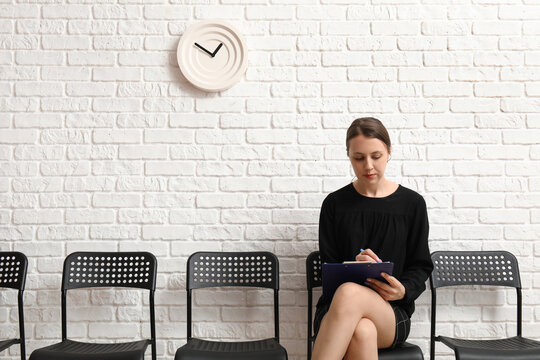 Young woman waiting for job interview in room