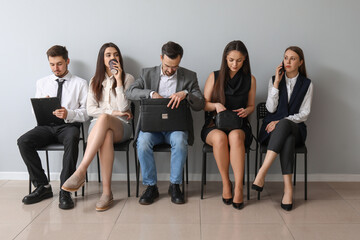 Young applicants waiting for job interview in room