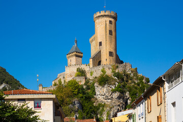 Fototapeta na wymiar View from city streets on towers of medieval fortress Chateau de Foix, France..