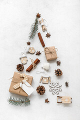 Christmas tree made of beautiful decorations and gift boxes on white background