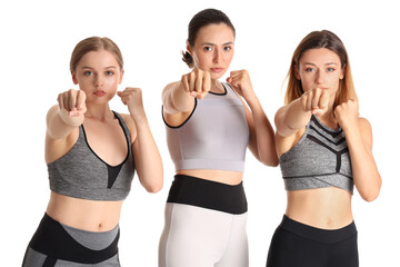 Young women training on white background. Concept of self defense
