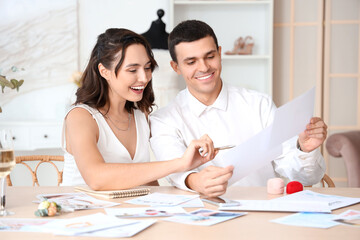 Young couple planning their wedding in office