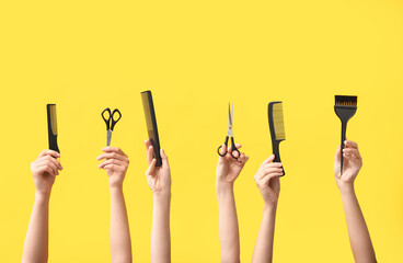 Many female hands with hair supplies on yellow background.