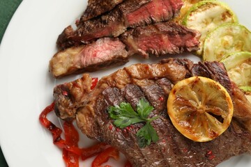 Delicious grilled beef steak and vegetables on plate, top view