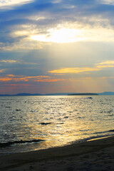 Evening ocean shore with reflections on the water