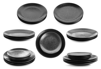 Stacks of black ceramic plates isolated on white, set