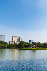 Fototapeta premium Hoan Kiem lake in Hanoi, Vietnam, with famous Turtle tower. An iconic lake, downtown Hanoi, Vietnam 
