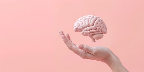 hand holding a 3D brain over a pink background - obrazy, fototapety, plakaty