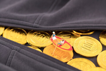 Miniature scene rowing on a golden coin