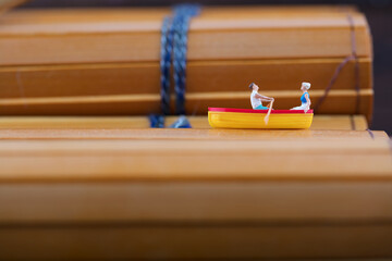 Miniature photography boating on bamboo slips